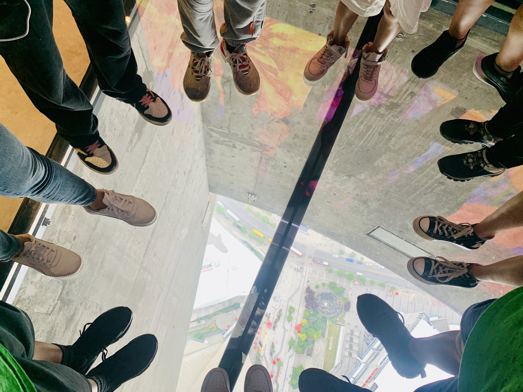 Students standing in a circle on the glass floor at the CN Tower Open Gallery